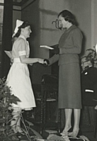 Nurse B A Brealey receiving Matrons prize for best practical nurse from the Countess of Derby.